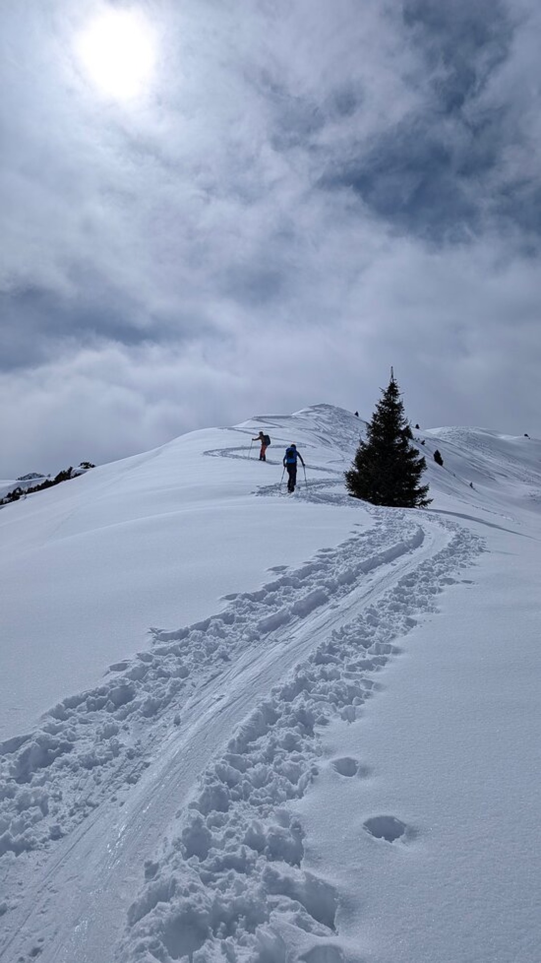 Ski tourers on the snowy ridge in Jyrgalan