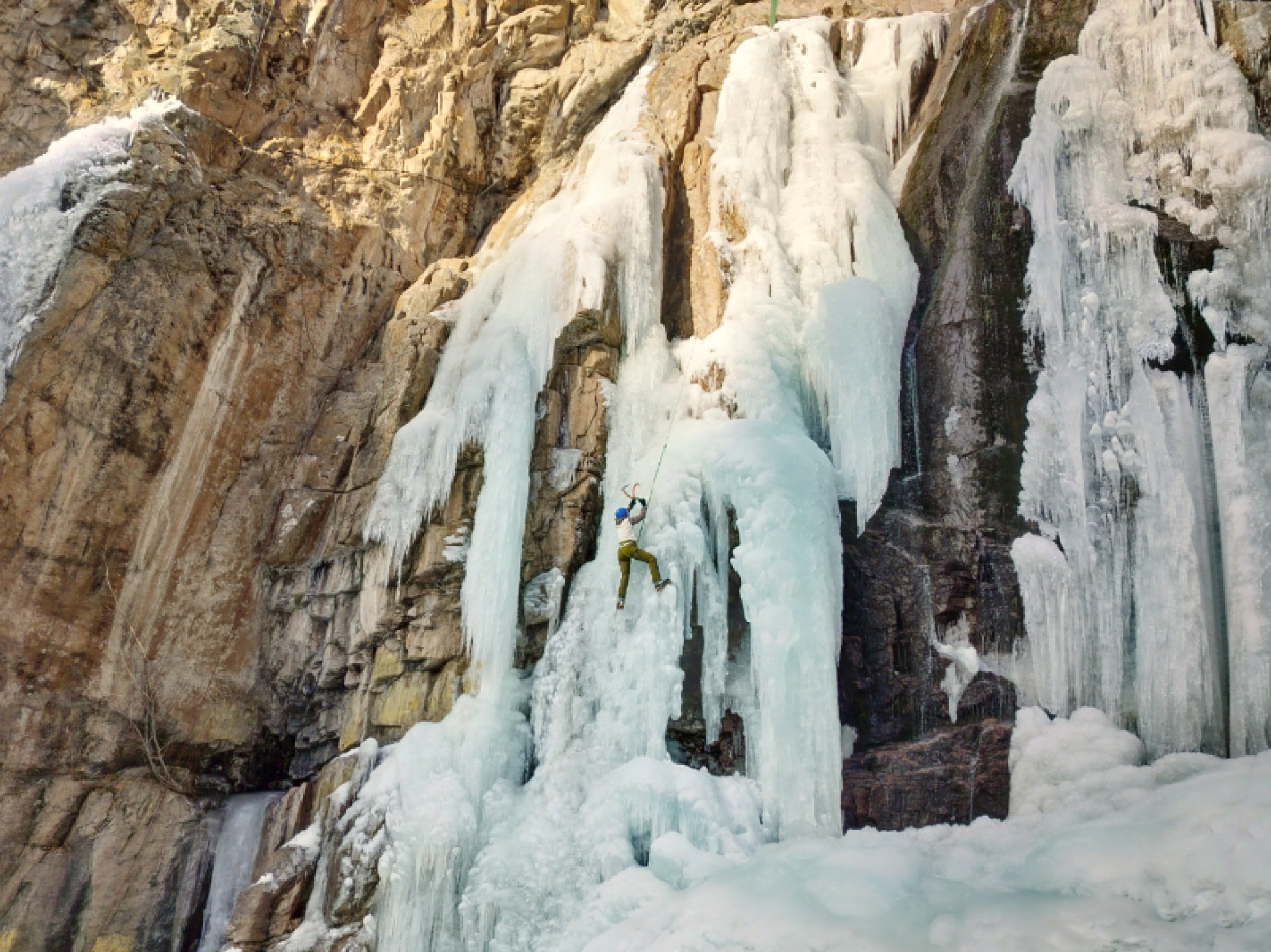 A climber on rock and ice